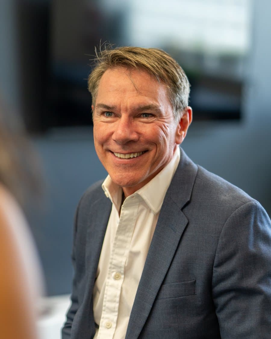 Neil James, Certified EOS Implementer, in conversation at a boardroom table